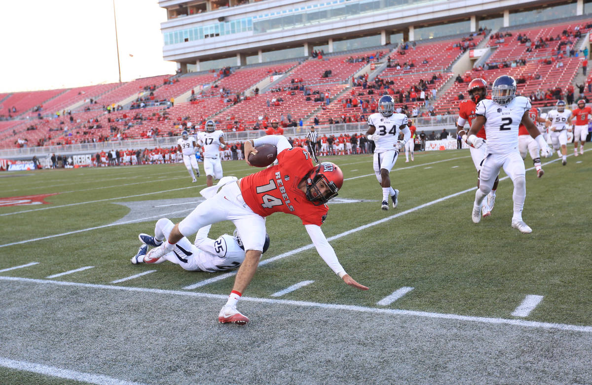 Brett Le Blanc/Special to the Pahrump Valley Times UNLV quarterback Kurt Palandech is pushed ou ...