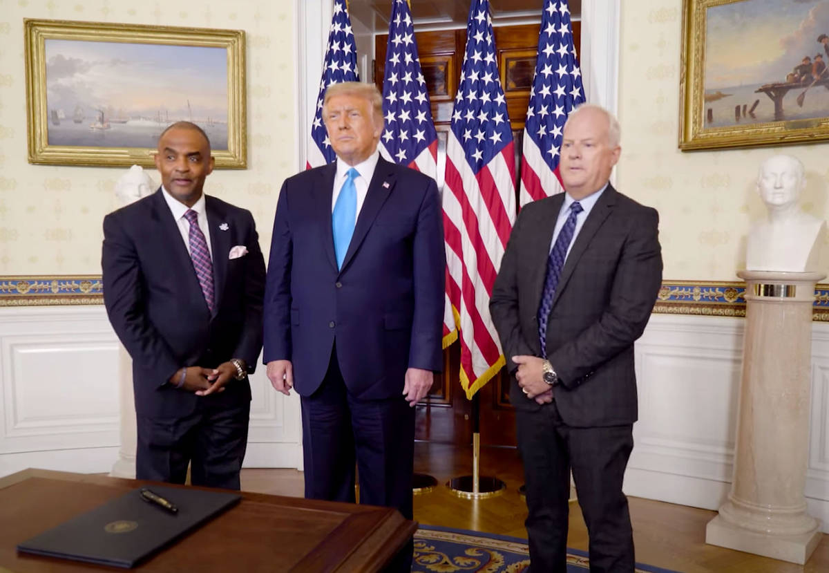 This image from video shows Nevada bank robber Jon Ponder, left, President Trump, center, and f ...