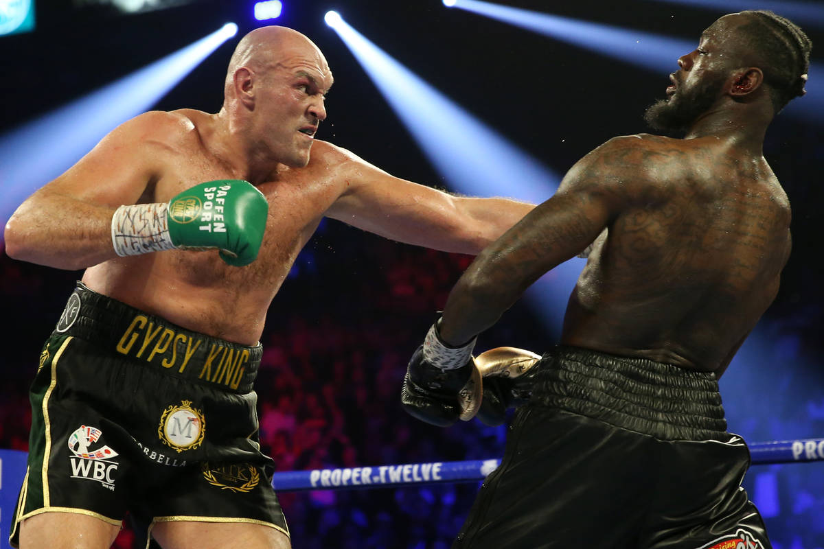 Deontay Wilder slips under Tyson Fury in round 4 of the WBC world heavyweight championship bout ...