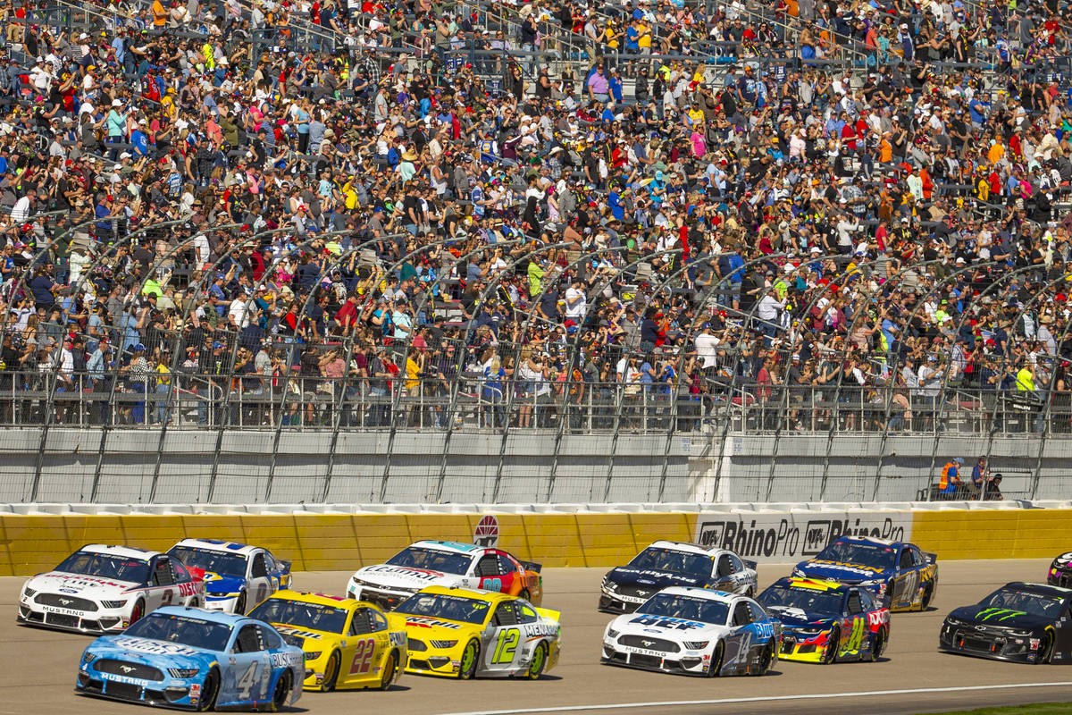 Kevin Harvick (4, bottom left) leads the race heading into turn one during the Pennzoil 400 pre ...