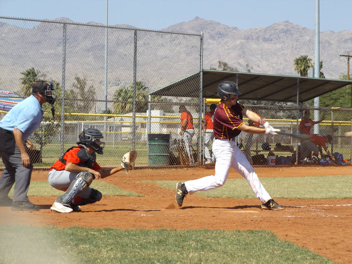 Charlotte Uyeno/Pahrump Valley Times Catcher Coby Tillery connects for a hit for Trojans Gold d ...