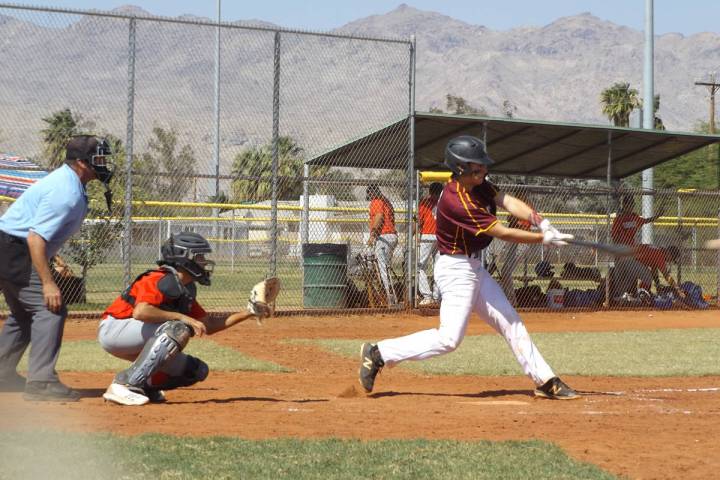 Charlotte Uyeno/Pahrump Valley Times Catcher Coby Tillery connects for a hit for Trojans Gold d ...