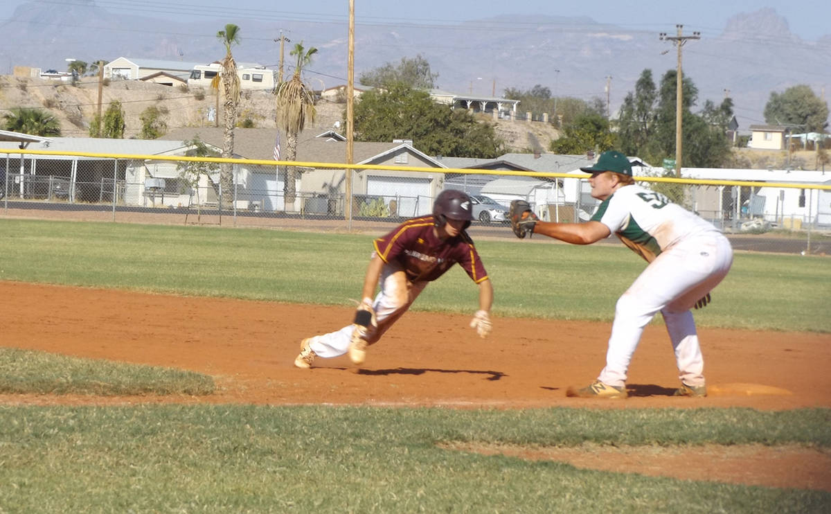 Charlotte Uyeno/Pahrump Valley Times James Metscher scrambles back to first base in anticipatio ...