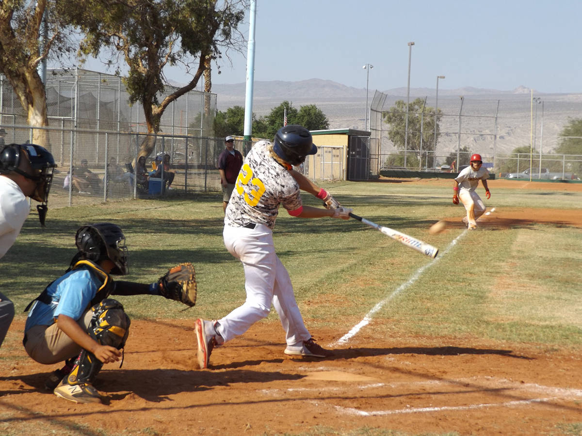 Charlotte Uyeno/Pahrump Valley Times Scott Oscarson gets a hit for Trojans Maroon during the Pi ...