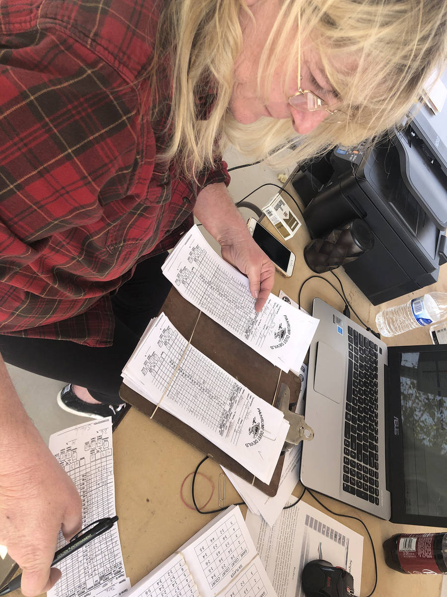 Tom Rysinski/Pahrump Valley Times Inundated with score sheets, Stacie Nicosia works to enter th ...