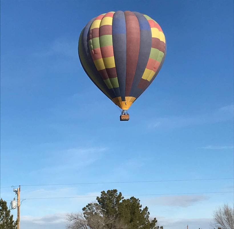 Robin Hebrock/Pahrump Valley Times A hot air balloon floats over a Pahrump Valley neighborhood.