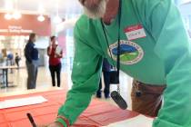 K.M. Cannon/Las Vegas Review-Journal Steve Radley, 73, of Pahrump, signs a banner during the Co ...