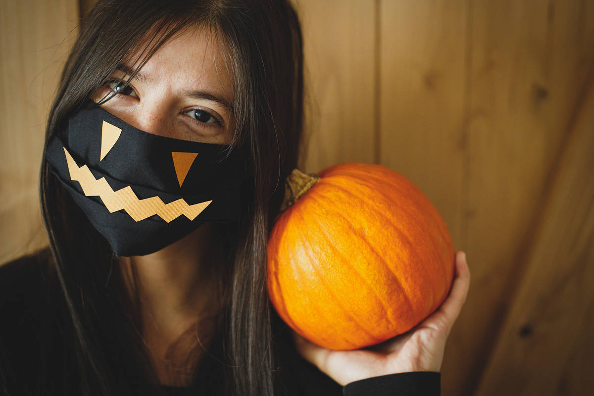 Getty Images A Halloween mask is not a substitute for a cloth face mask, and a costume mask sh ...