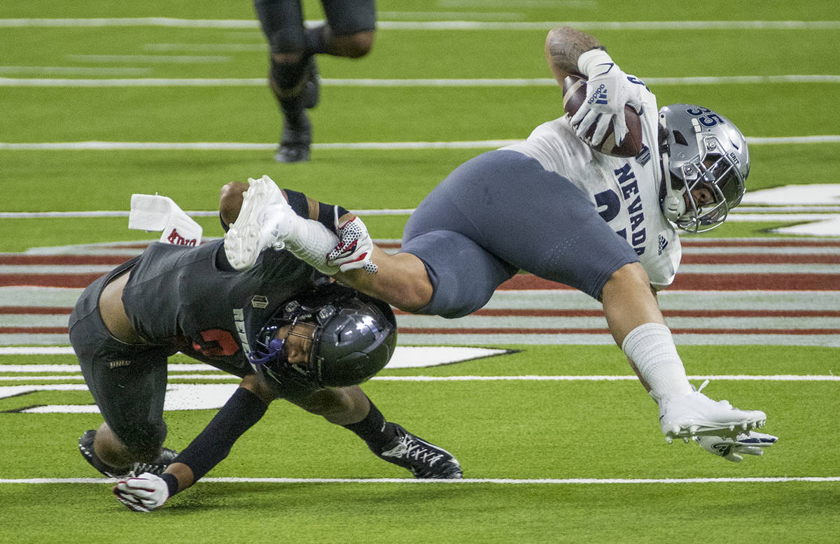 L.E. Baskow/Special to the Pahrump Valley Times UNR running back Toa Taua, right, is taken down ...