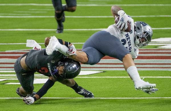 L.E. Baskow/Special to the Pahrump Valley Times UNR running back Toa Taua, right, is taken down ...