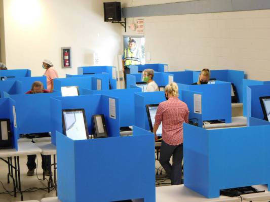 Robin Hebrock/Pahrump Valley Times Voters are seen casting their ballots on electronic voting m ...