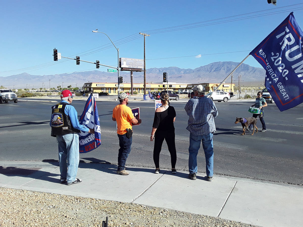 Selwyn Harris/Pahrump Valley Times Waving a Trump banner, Bruce Schoenberger, at left, noted th ...