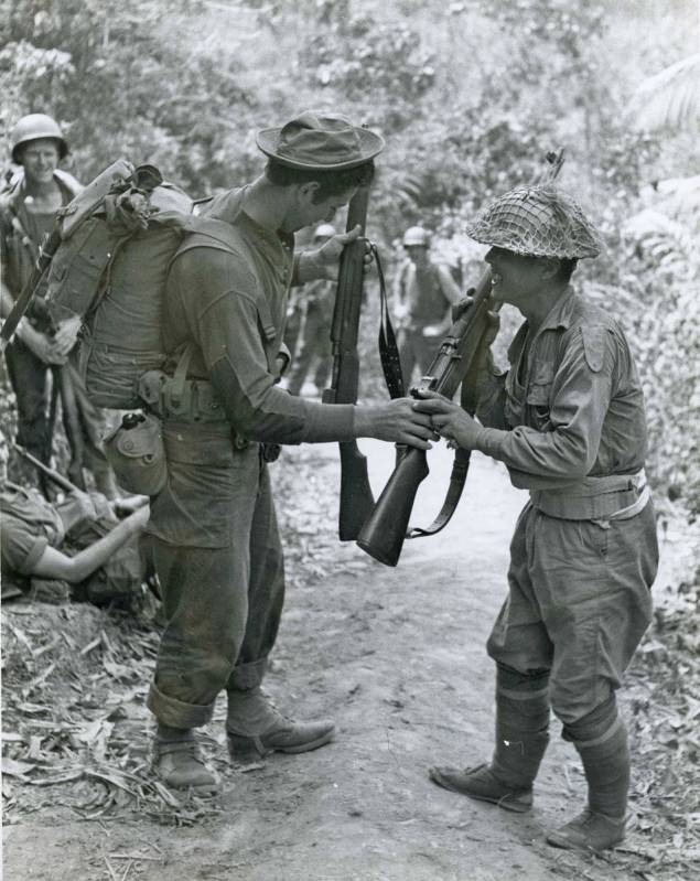 Special to the Pahrump Valley Times Bernard “Marty” Martin, at left, compares rifles with a ...