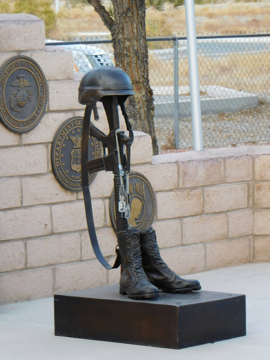 Robin Hebrock/Pahrump Valley Times A war memorial battle cross, boots, gun and helmet sculpture ...