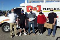 Selwyn Harris/Pahrump Valley Times Holding a Thanksgiving dinner package, D&J Electrical Servic ...