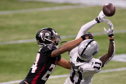 Las Vegas Raiders wide receiver Henry Ruggs III (11) attempts to bring in a catch over Atlanta ...