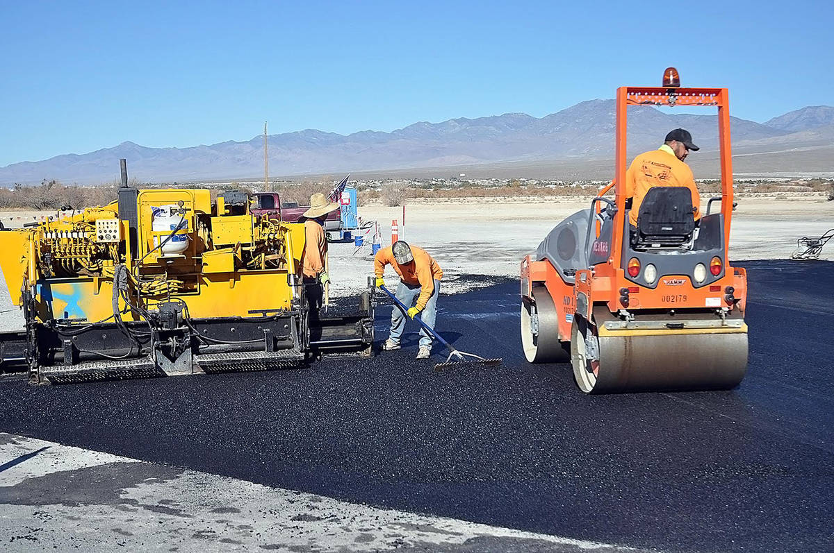 Horace Langford Jr./Pahrump Valley Times Work crews are seen paving a portion of the parking l ...