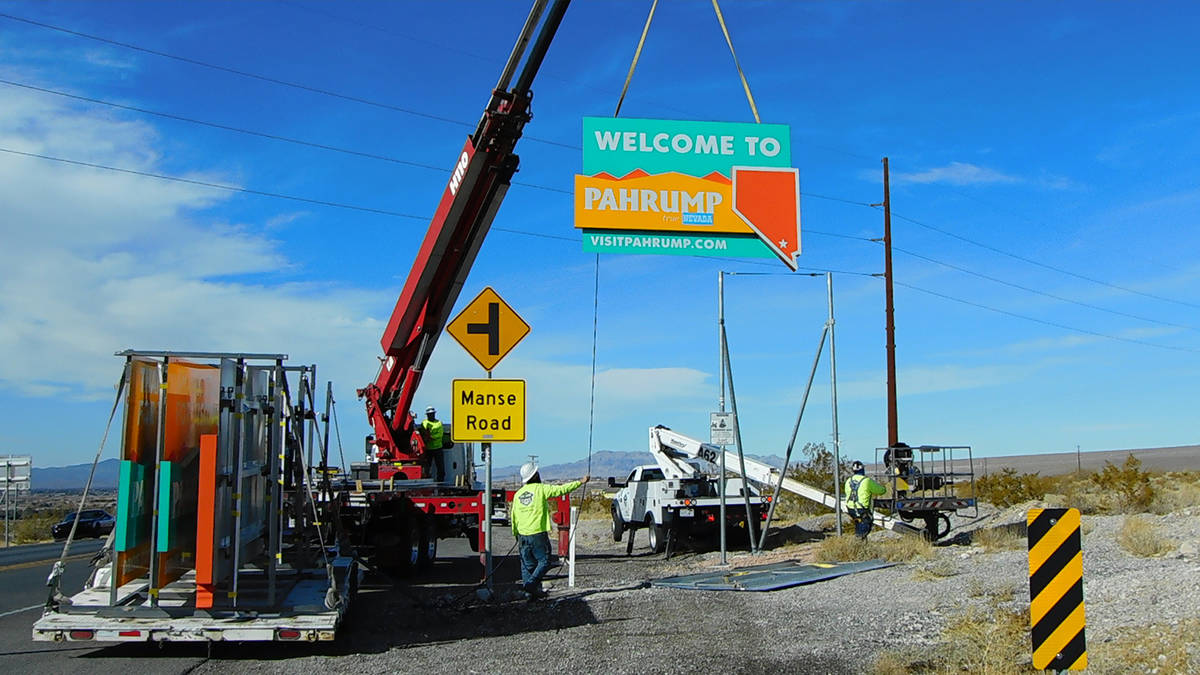 Robin Hebrock/Pahrump Valley Times High Impact Signs and Designs is pictured installing a new " ...