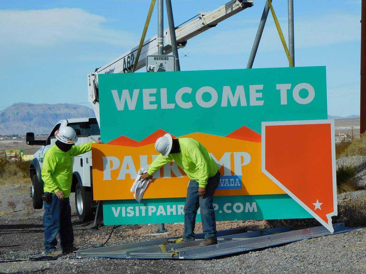 Robin Hebrock/Pahrump Valley Times Work crews give the new welcome signs a wipe-down prior to i ...
