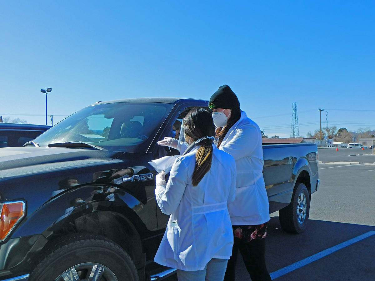 Robin Hebrock/Pahrump Valley Times Officials with Immunize Nevada are shown organizing paperwor ...