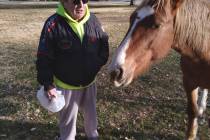 Selwyn Harris/Pahrump Valley Times Pahrump resident Joe Proenza visits with a wild mustang at t ...