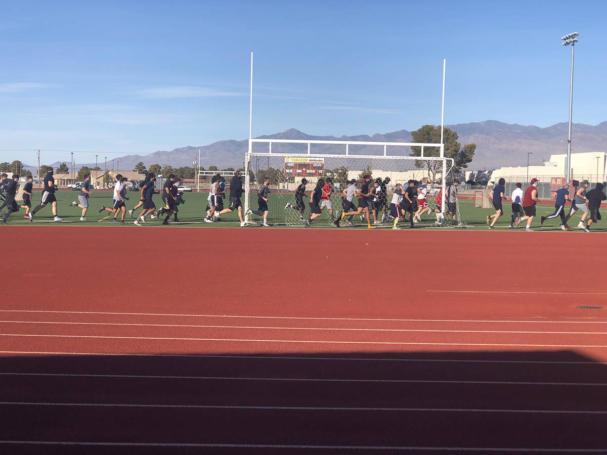 Tom Rysinski/Pahrump Valley Times Football players run a lap around the field before the start ...