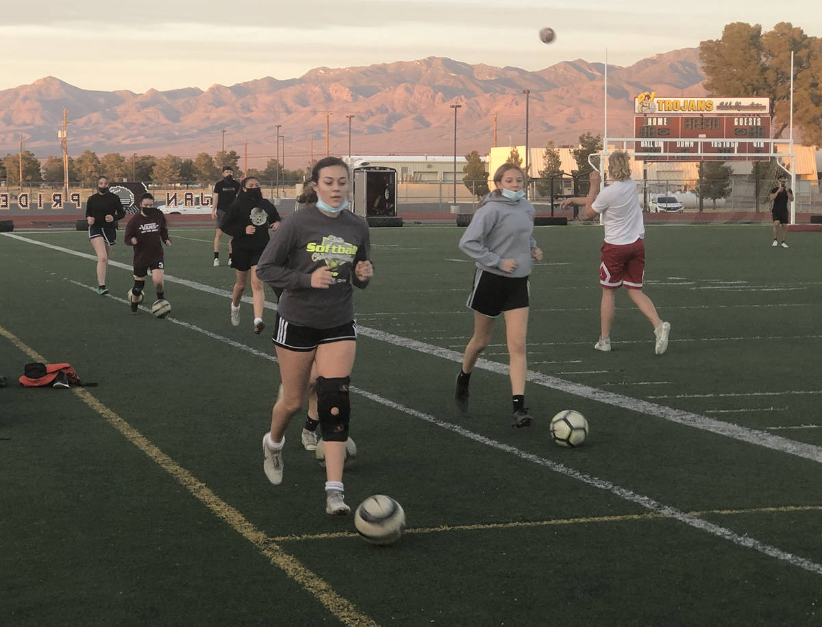 Tom Rysinski/Pahrump Valley Times Girls soccer players warm up before a conditioning session wh ...