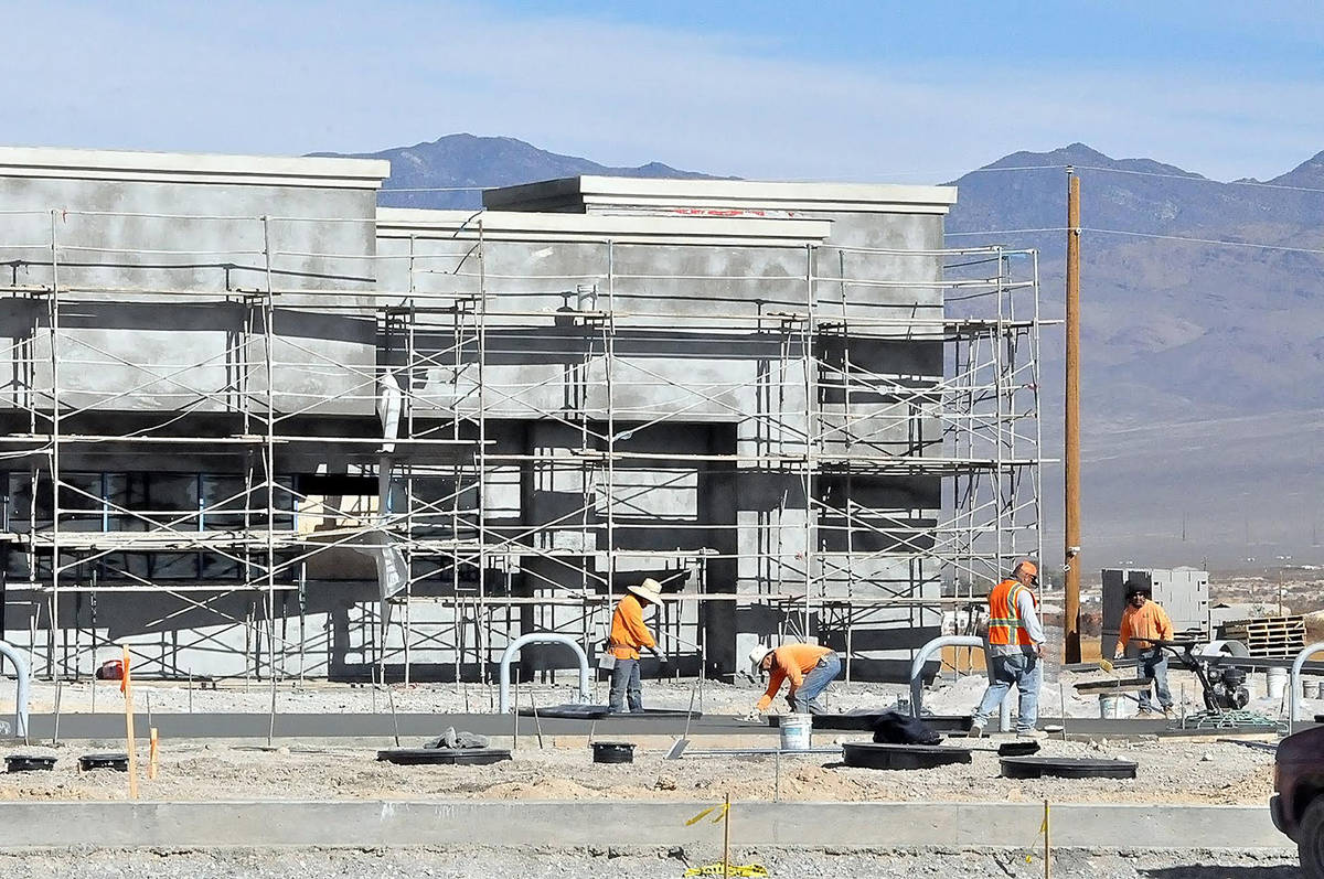 Horace Langford Jr./Pahrump Valley Times MO Construction workers are seen performing concrete w ...