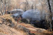 Getty Images Beatty Volunteer Fire Department Chief Mike Harmon (left) and fireman Amina Ander ...