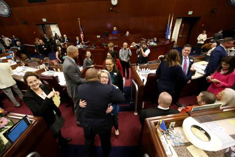 Assembly Speaker Jason Frierson, D-Las Vegas, hugs Sarah Peters, D-Reno, as female lawmakers wa ...