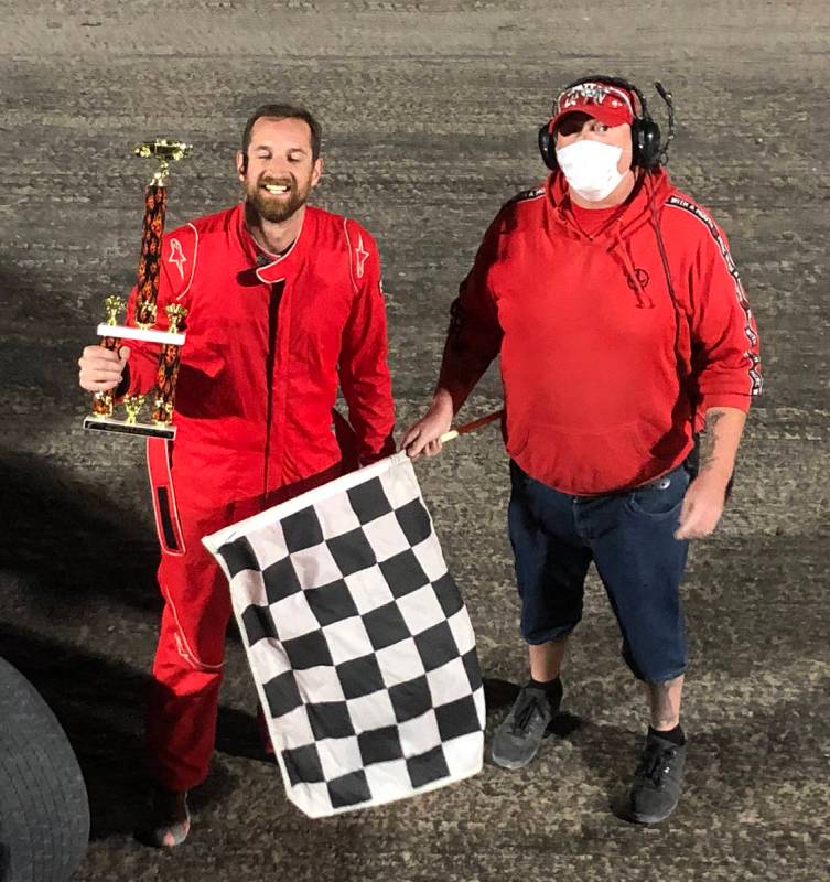 Tom Rysinski/Pahrump Valley Times Kyle Renberger, left, accepts the trophy from flagman Dale Ge ...