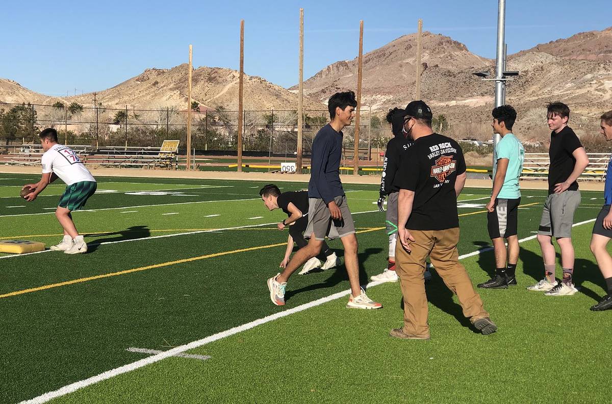 Tom Rysinski/Pahrump Valley Times Football players take turns running a drill as assistant coac ...