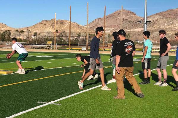 Tom Rysinski/Pahrump Valley Times Football players take turns running a drill as assistant coac ...