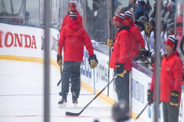 Vegas Golden Knights head coach Pete DeBoer, center, looks on as the team practices on an outdo ...