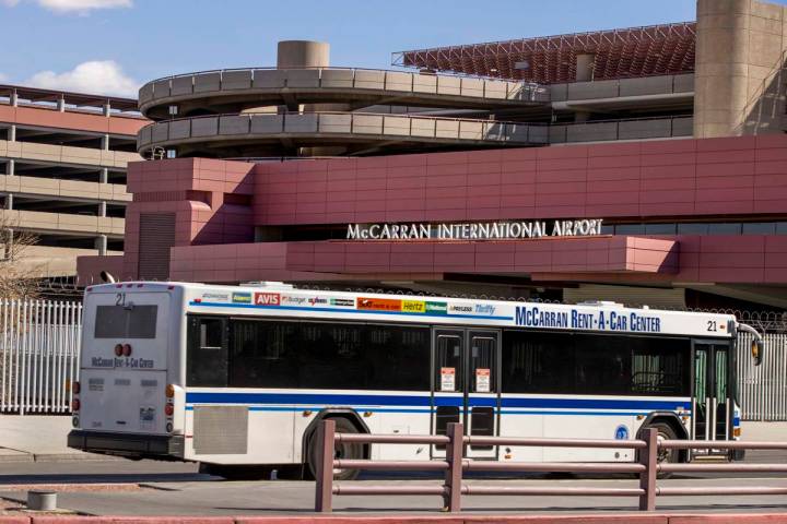 A rental car transport bus passes the Terminal 1 baggage area at McCarran International Airport ...