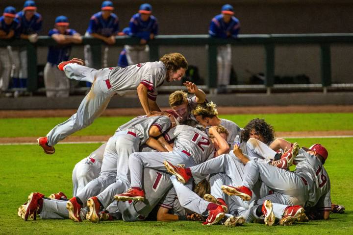 Desert Oasis players celebrate their win over Reno 9-1 during the tie-breaker game of their Cla ...