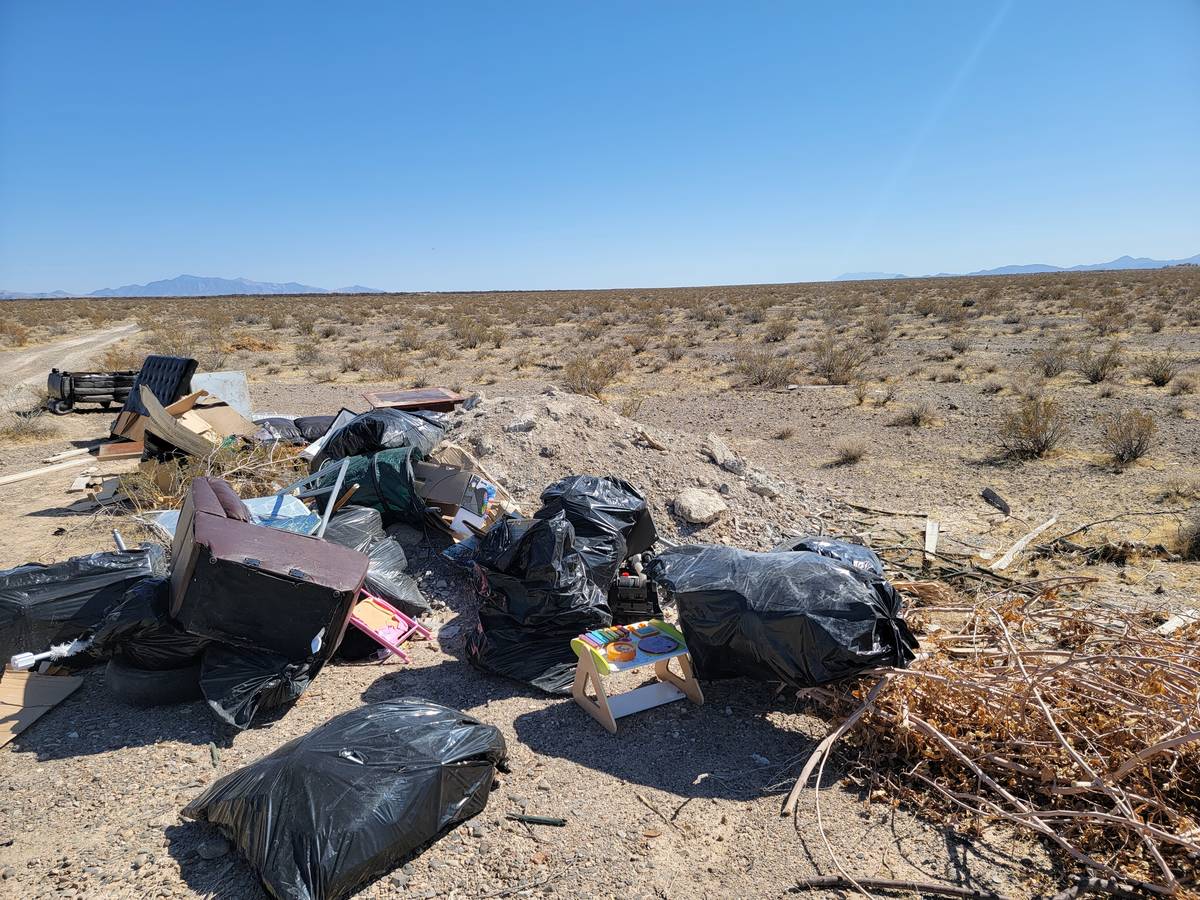 Tim Burke/Special to the Pahrump Valley Times Posting signs that dumping is illegal and carries ...
