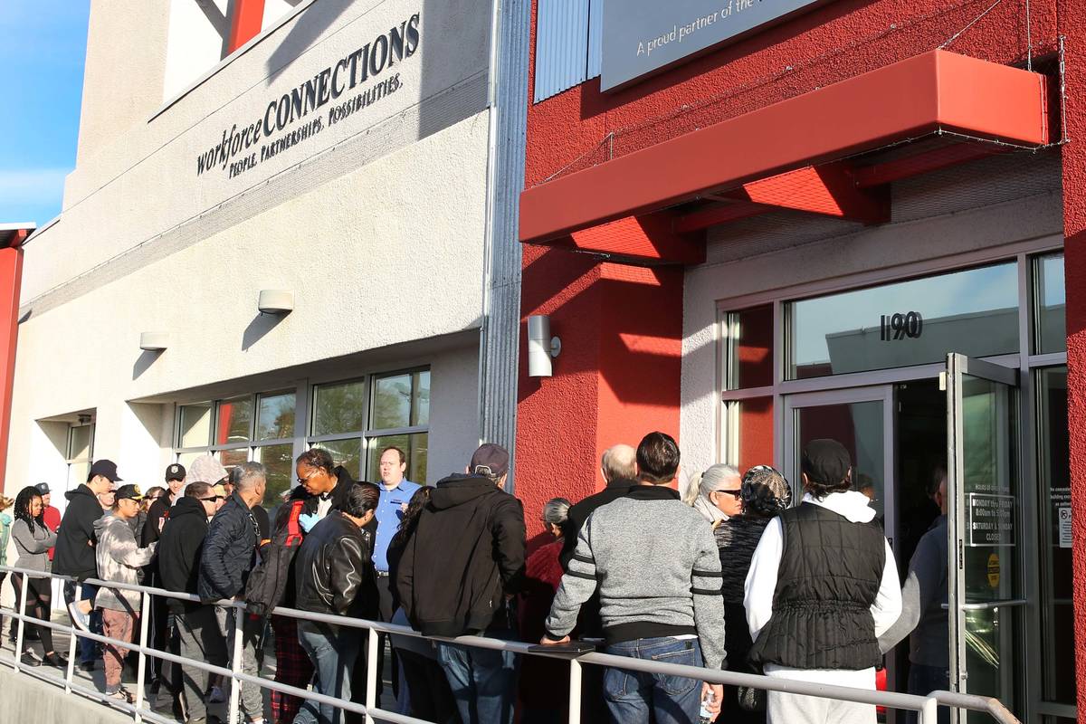 People wait in line at One-Stop Career Center in this March 16, 2020, file photo. (Bizuayehu Te ...