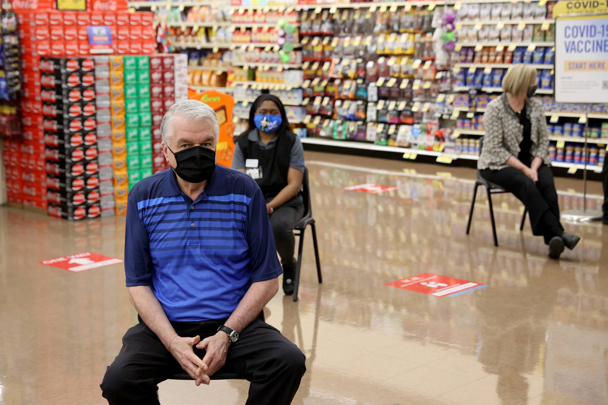 Gov. Steve Sisolak waits to receive his COVID-19 vaccine alongside frontline grocery store work ...