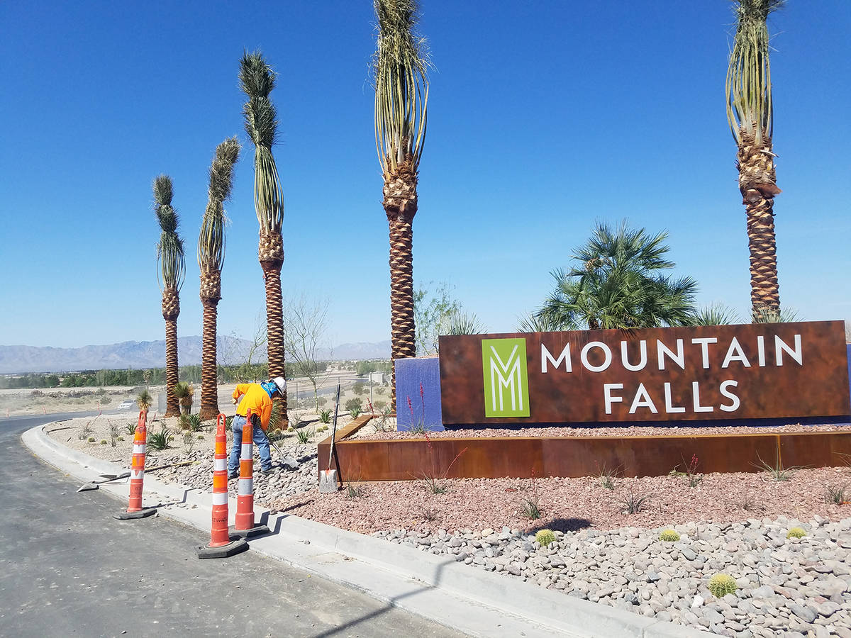 Horace Langford Jr./Pahrump Valley Times Crews work outside the Mountain Falls Development as ...