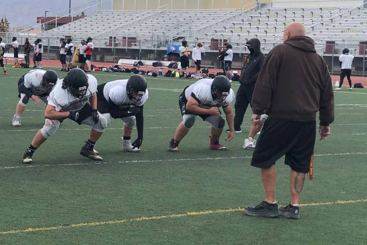 Tom Rysinski/Pahrump Valley Times Line coach Fred Schmidt runs a drill during Pahrump Valley Hi ...