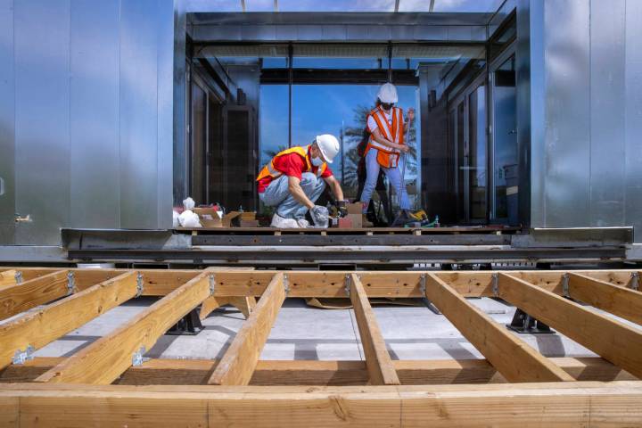 Student Jorge Medina, left, begins to assemble parts for a deck soon to be installed as a UNLV ...