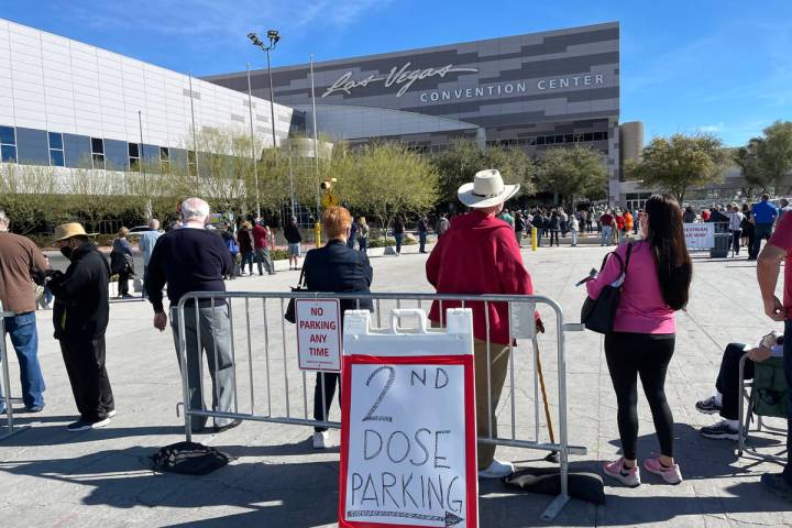 In this Feb. 11, 2021, file photo, people line up for the second dose of the COVID-19 vaccine o ...