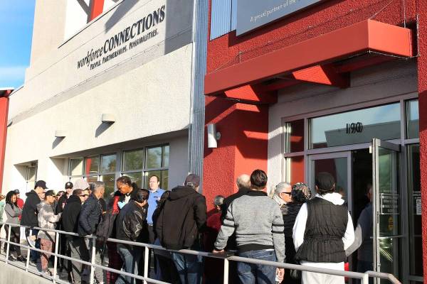 People wait in line at One-Stop Career Center in this March 16, 2020, file photo. (Bizuayehu Te ...