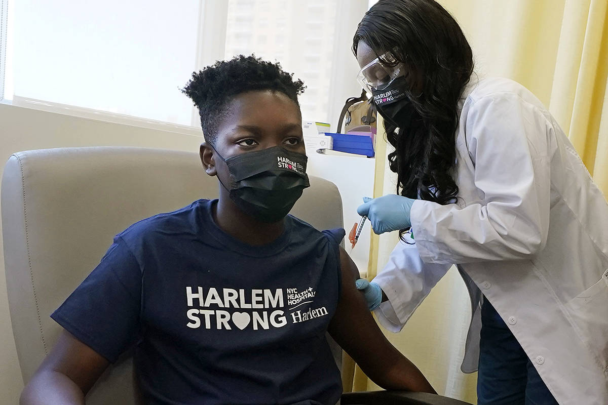 Julian Boyce, 14, receives his first Pfizer COVID-19 vaccination at NYC Health + Hospitals/Harl ...