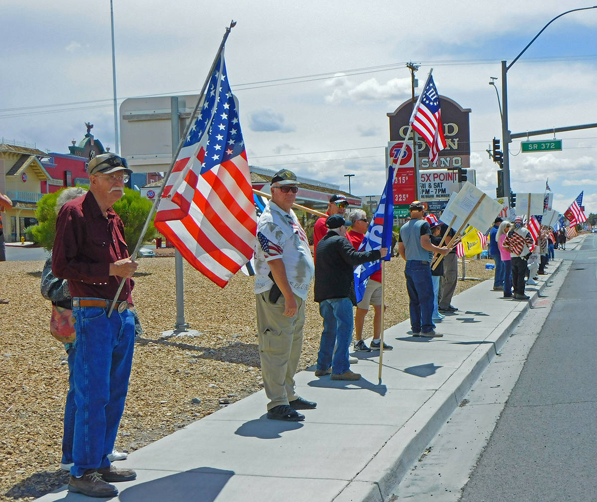Robin Hebrock/Pahrump Valley Times With flags and signs in hand, residents of the Pahrump Valle ...