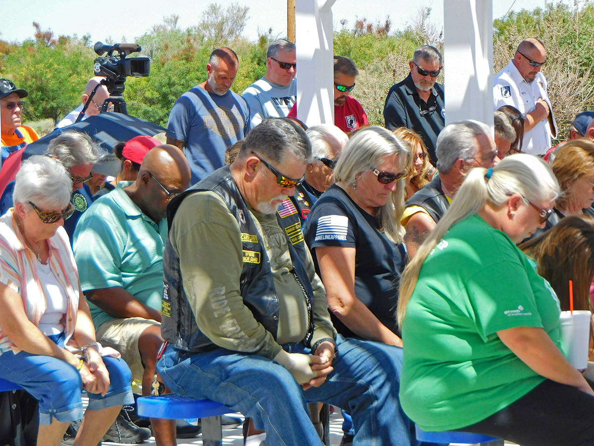 Robin Hebrock/Pahrump Valley Times Community members bow their heads in prayer during the Memor ...