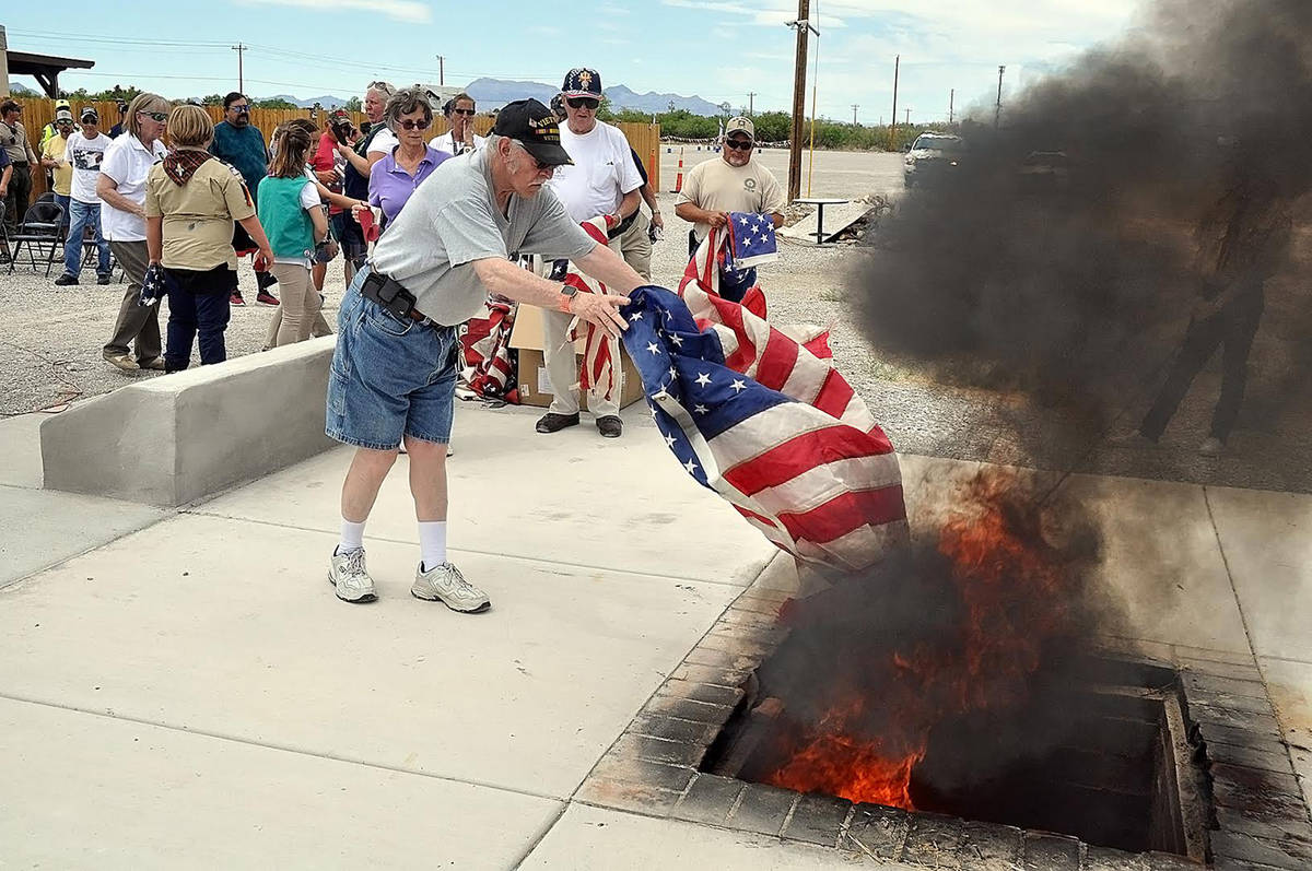 Horace Langford Jr./Pahrump Valley Times Local veteran Phil Raneri is pictured lowering an Amer ...