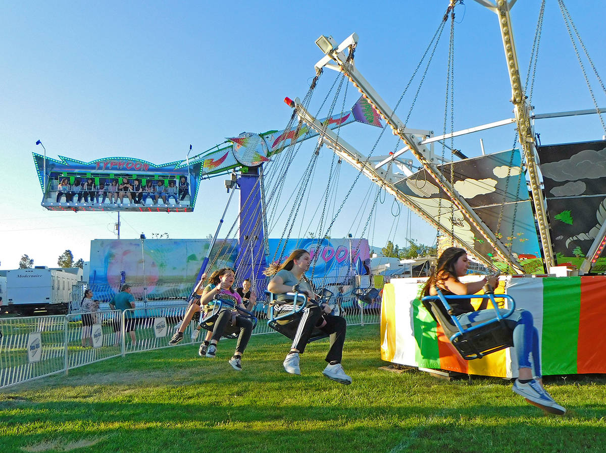 Robin Hebrock/Pahrump Valley Times Carnival-goers are pictured swinging round and round on one ...