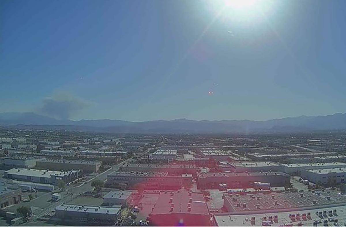 A plume of smoke rises from the Mount Potosi area as seen from a camera above Allegiant Stadium ...